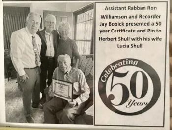 Picture of Herbert receiving his 50 year award from the El Jebel Shrine